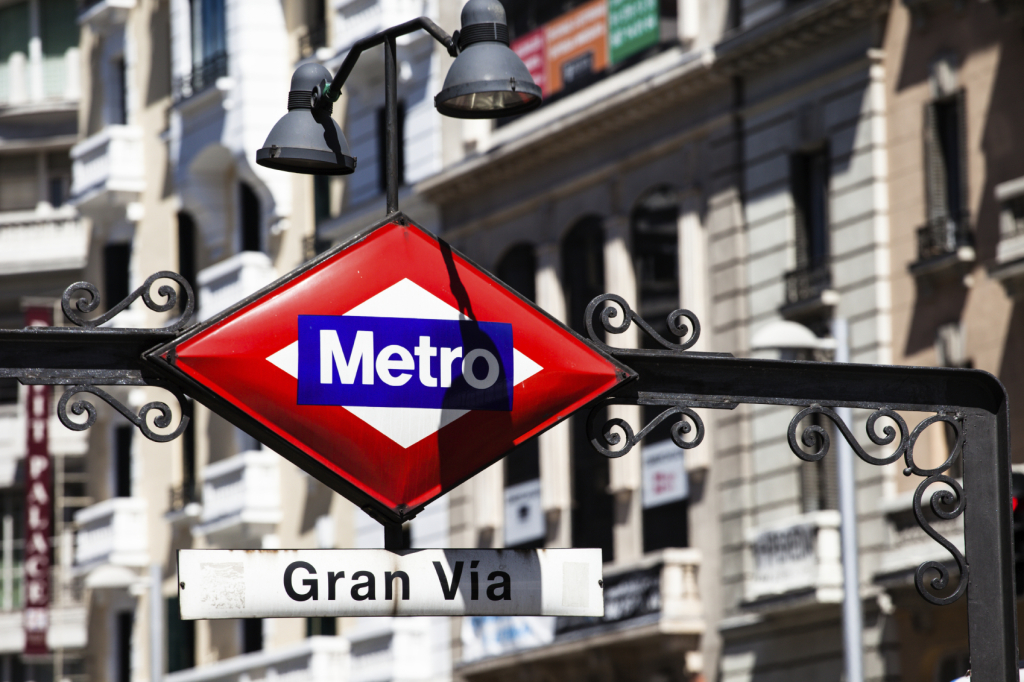 Metro Sign Gran Via on blurred city, Madrid