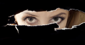 Women's eyes spying through a hole