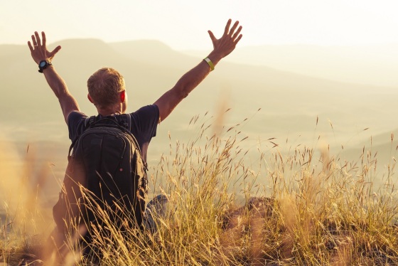 Man greeting golden rising of the sun
