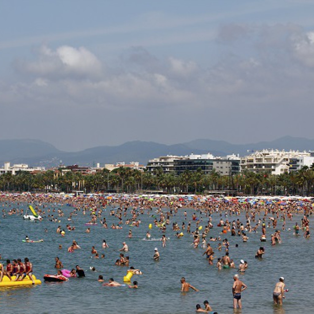 Crowded beach with pedal boats
