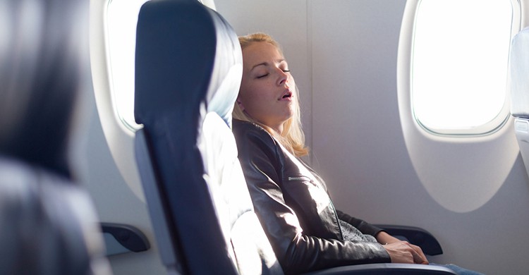 Mujer durmiendo en el avión