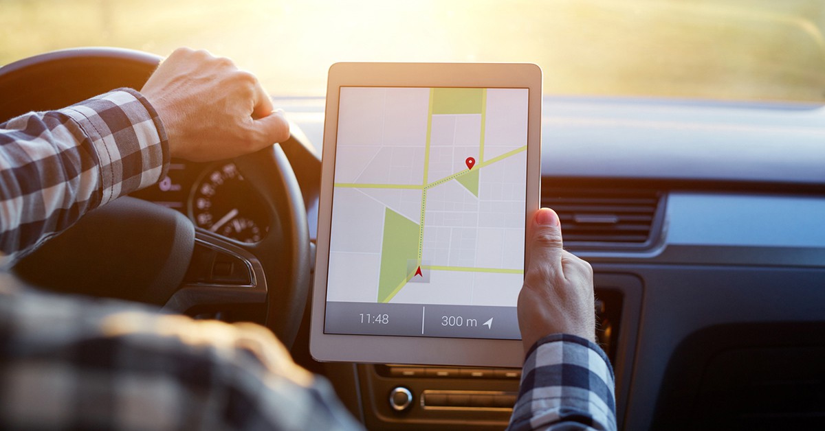 Un hombre mira el gas en una tableta dentro del coche